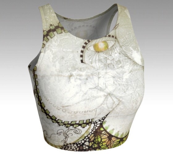 black and white and gold and green cosmic and geometric design on a womans face on yoga top