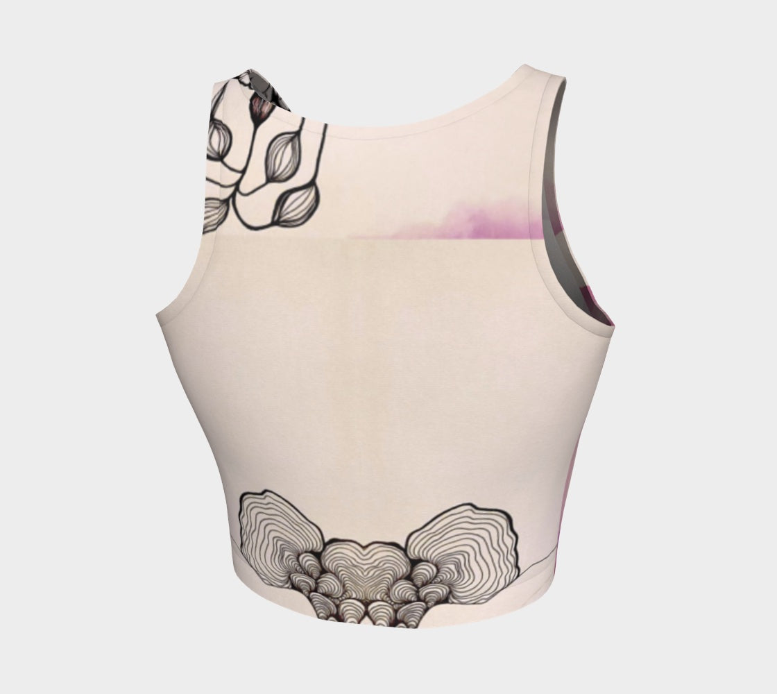 A beige yoga top with a floral and fungal design, featuring leaf patterns and what appears to be a stylized mushroom.