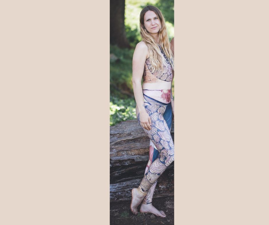 Yoga leggings with a woman face and reishi mushroom black lines painted on reclaimed wood with a gold earring and a red flower
