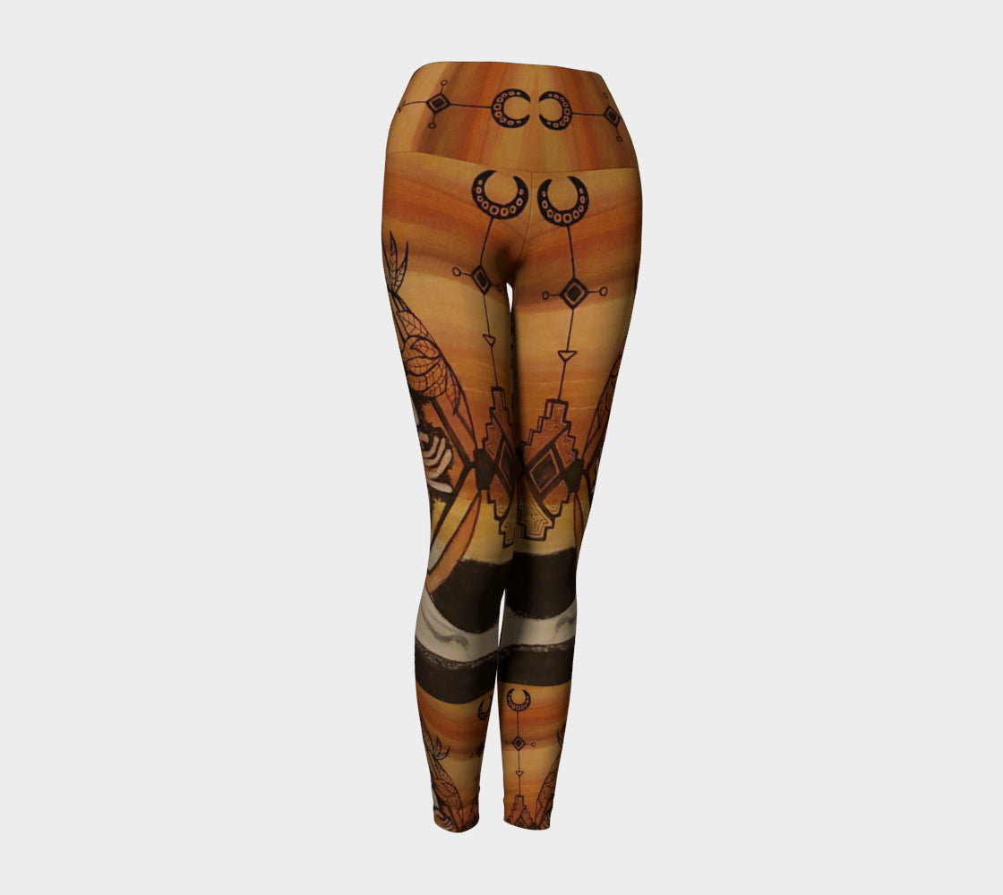 yoga leggings with a floral leaf line and crescent moon designs on a golden brown background.