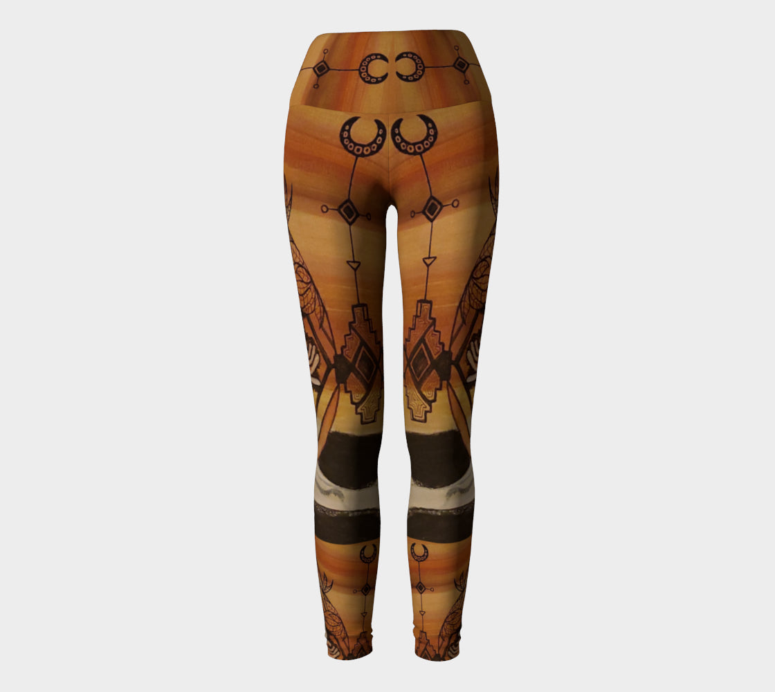 yoga leggings with a floral leaf line and crescent moon designs on a golden brown background.