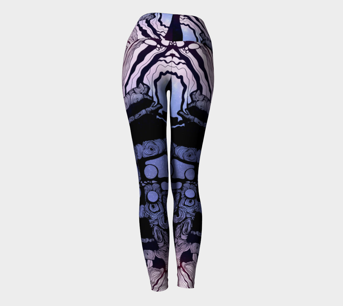 Yoga leggings in blue and purple with black line in the shape of a tree a woman and moons on them