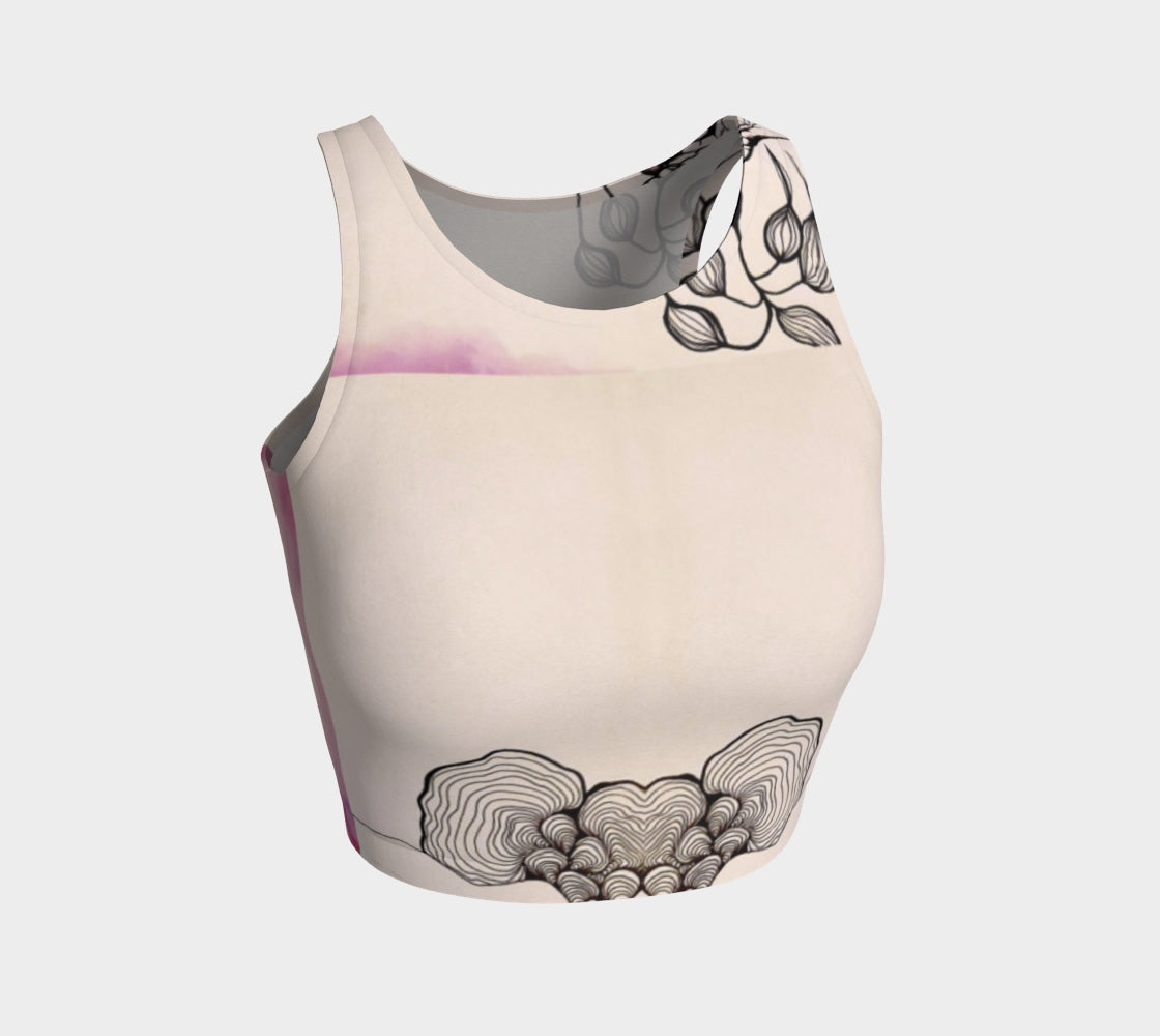 A beige yoga top with a floral and fungal design, featuring leaf patterns and what appears to be a stylized mushroom.