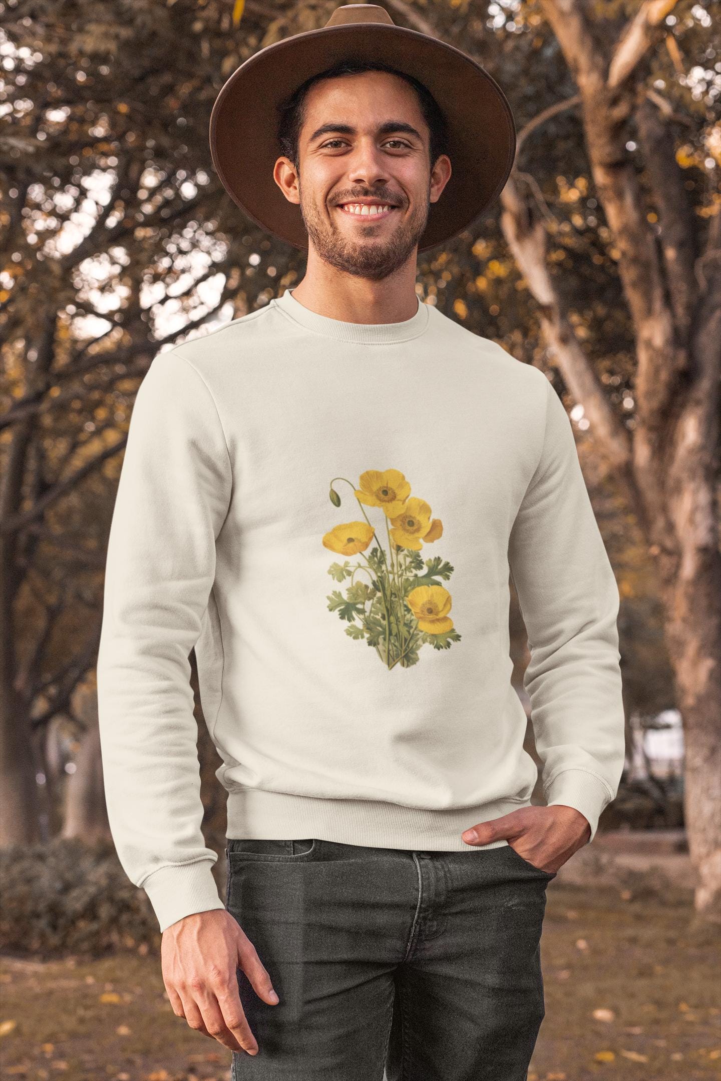 man wearing a cream colored crewneck sweatshirt with yellow poppies on it