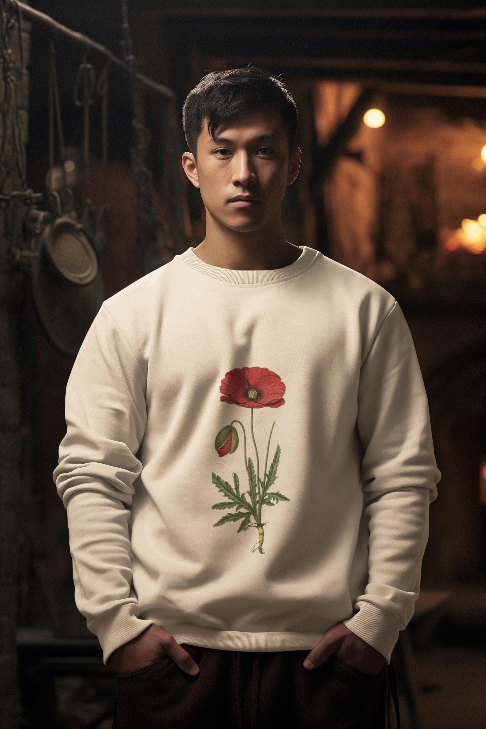 man wearing cream crew neck sweatshirt with a red poppy on it