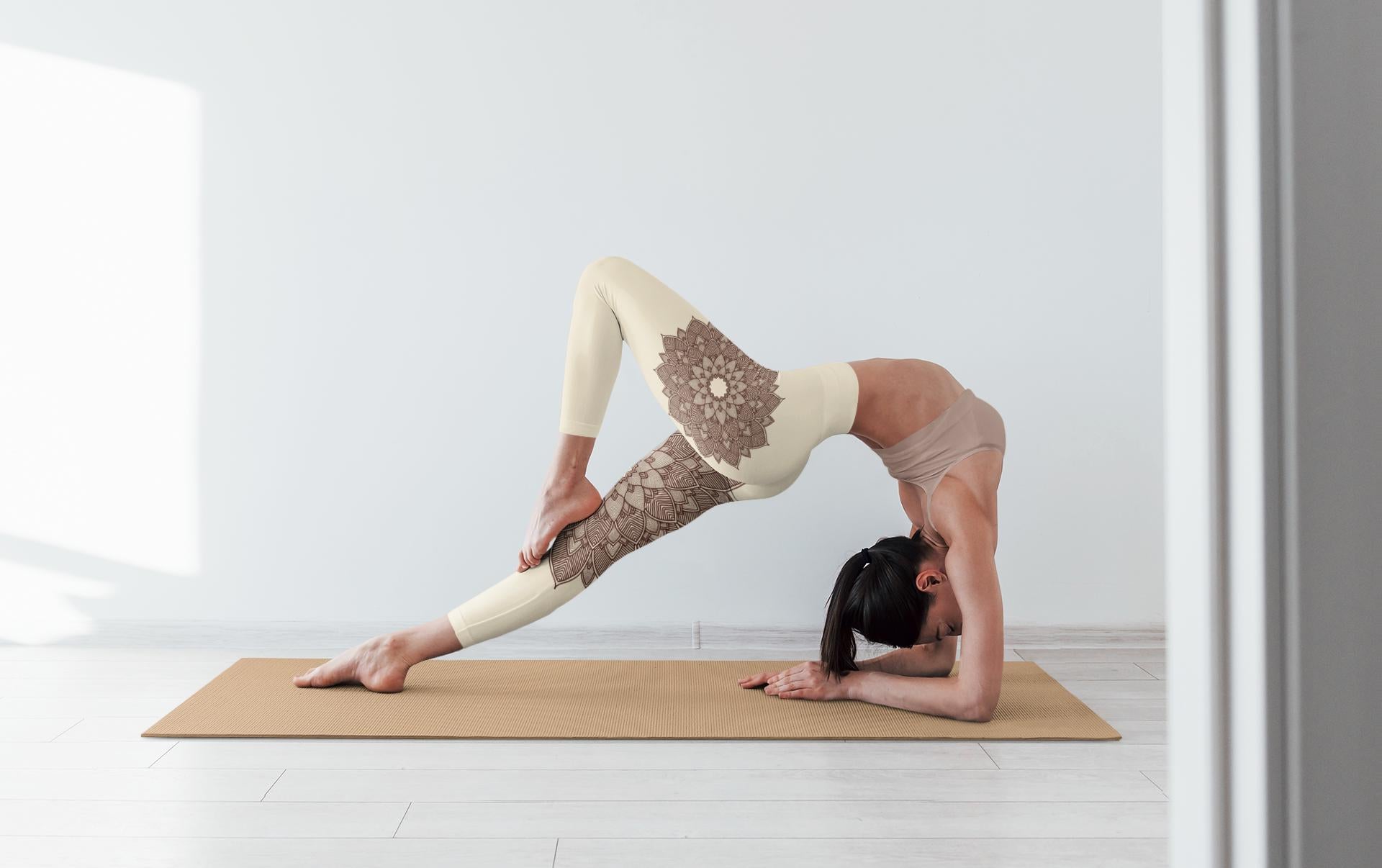 woman doing yoga and wearing coconut and cacao colored leggings with a lotus lace design on them