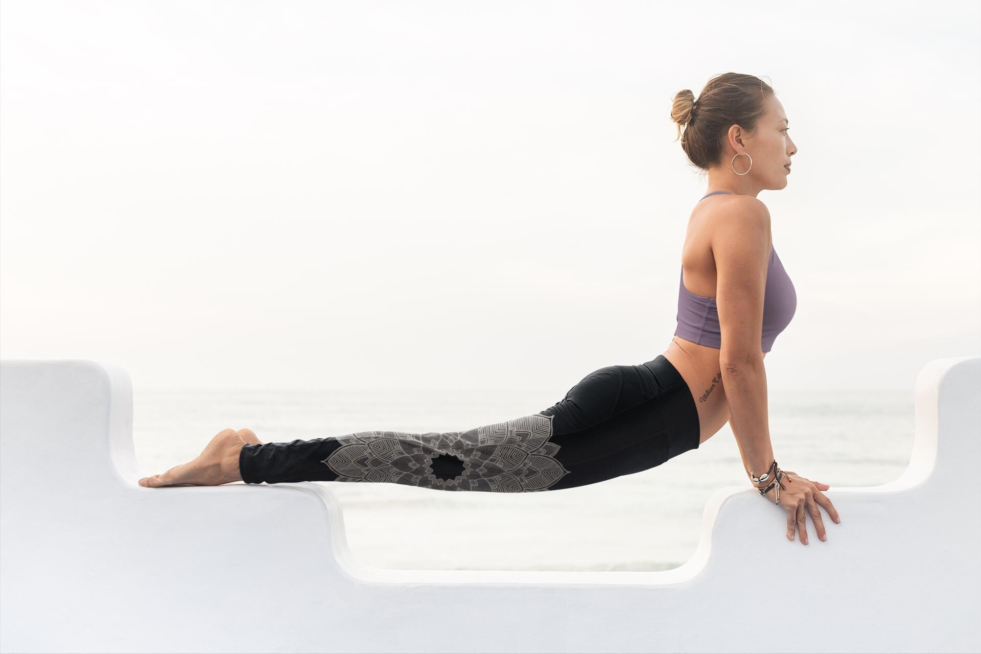 woman doing yoga wearing yoga leggings in black and ashwagandha