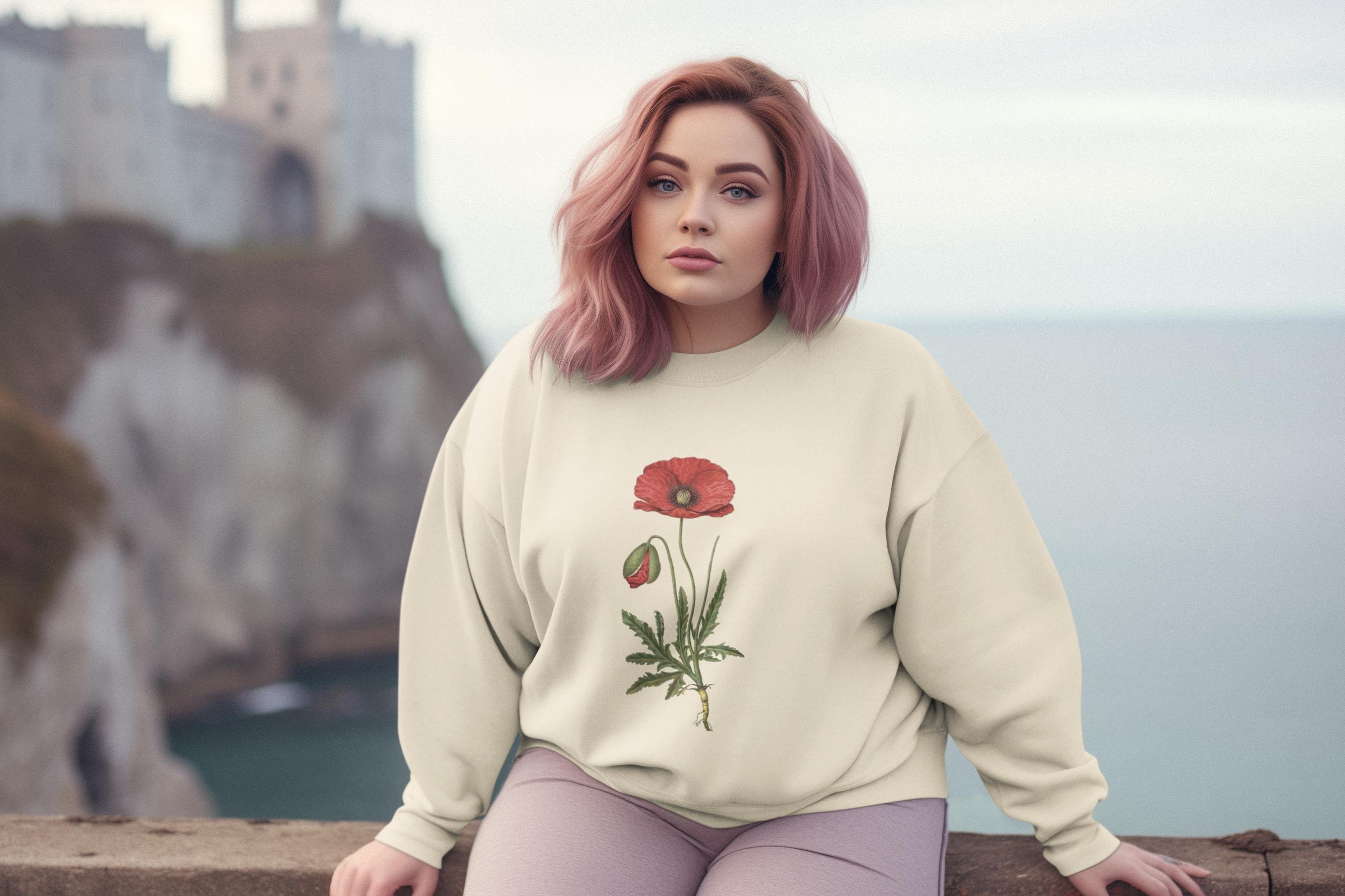 woman wearing cream crew neck sweatshirt with a red poppy on it