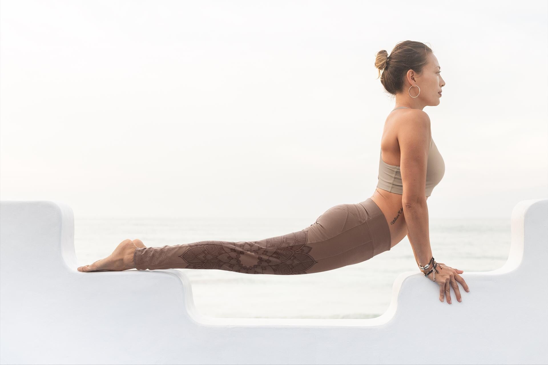 woman doing yoga and wearing cinnamon and cacao colored yoga leggings