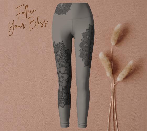 woman doing yoga and wearing yoga leggings in shades of heather grey and black with a lotus lace design on them