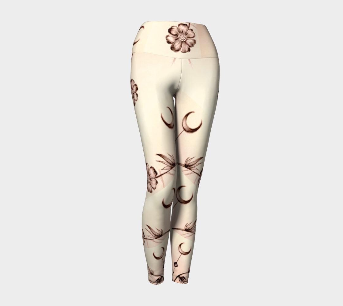 Black and white yoga leggings with flower and crescent moon design on them