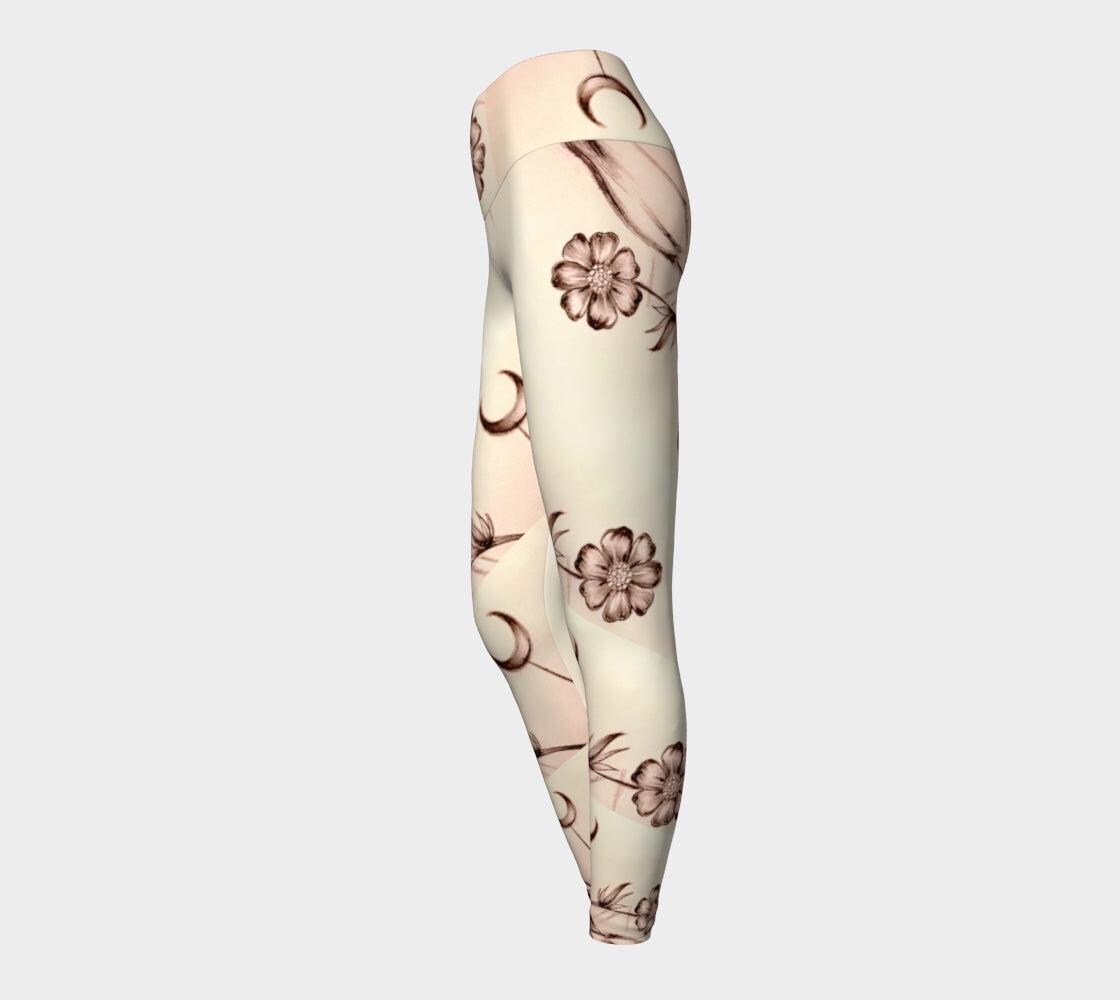 Black and white yoga leggings with flower and crescent moon design on them