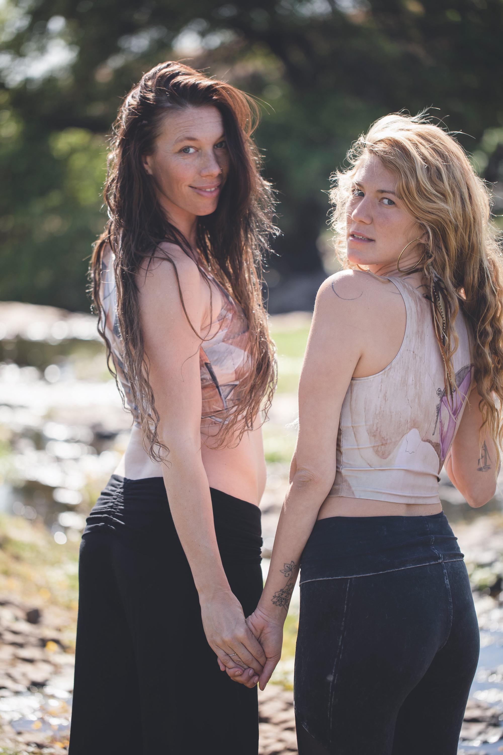 yoga top on two models  with purple butterfly painted on wood grain