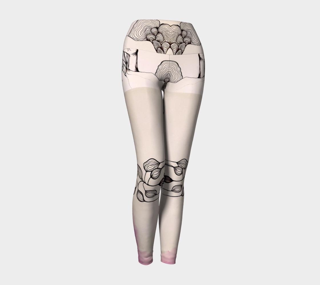 Black and white yoga leggings with designs of hands and plants and subtle hues of pink of them
