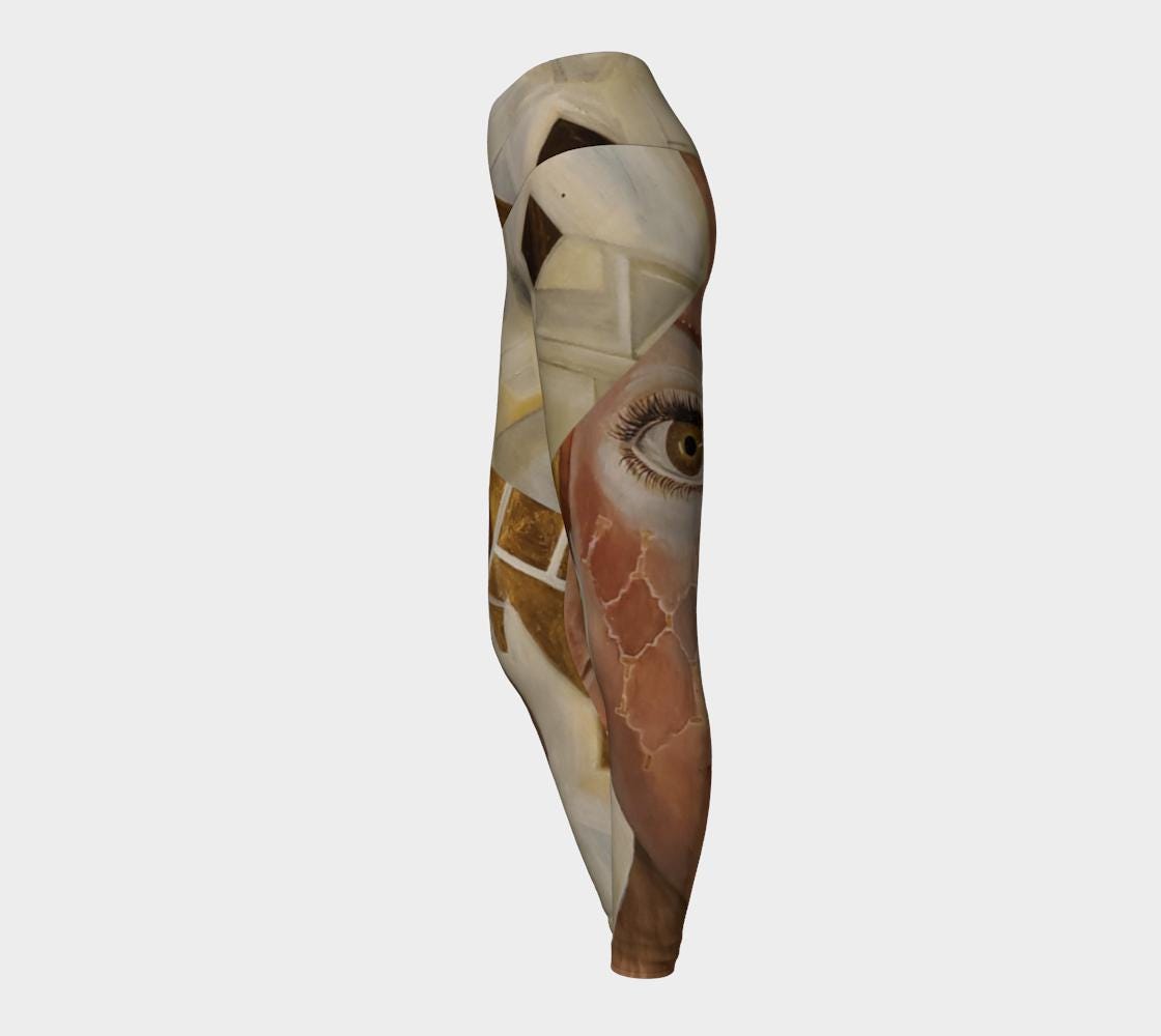 Yoga leggings in shades of white cream and gold with pink accents and geometric gold shapes