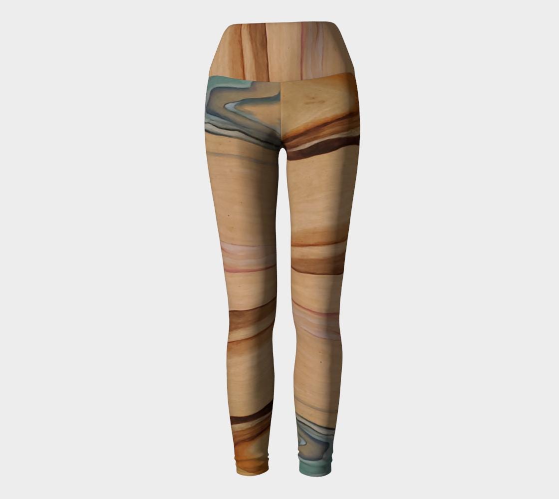 Yoga leggings in shades of brown and beige and blue and pink on reclaimed wood grain
