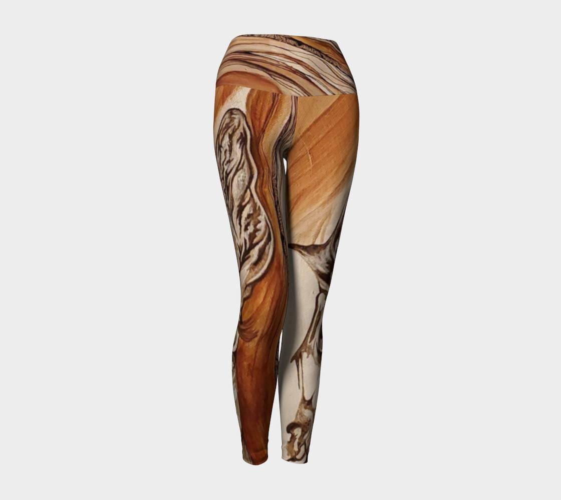 Yoga leggings in shades of rust and brown with the face of a doe drawn on them in black and white lines