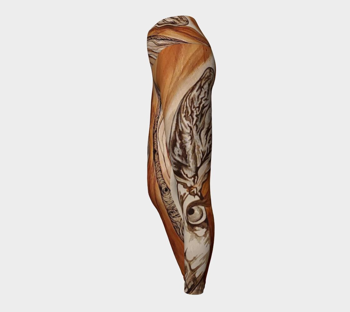 Yoga leggings in shades of rust and brown with the face of a doe drawn on them in black and white lines