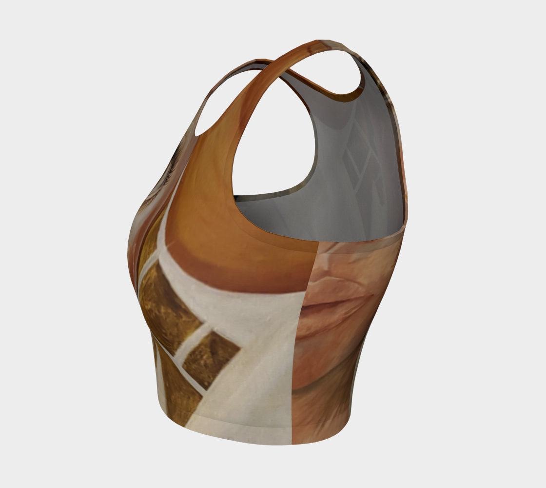 A crop top featuring a geometric pattern with diamonds in gold, black, and white, and wide open eyes on the front.