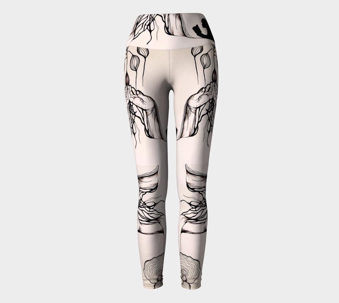 Black and white yoga leggings with designs of hands and plants and subtle hues of pink of them