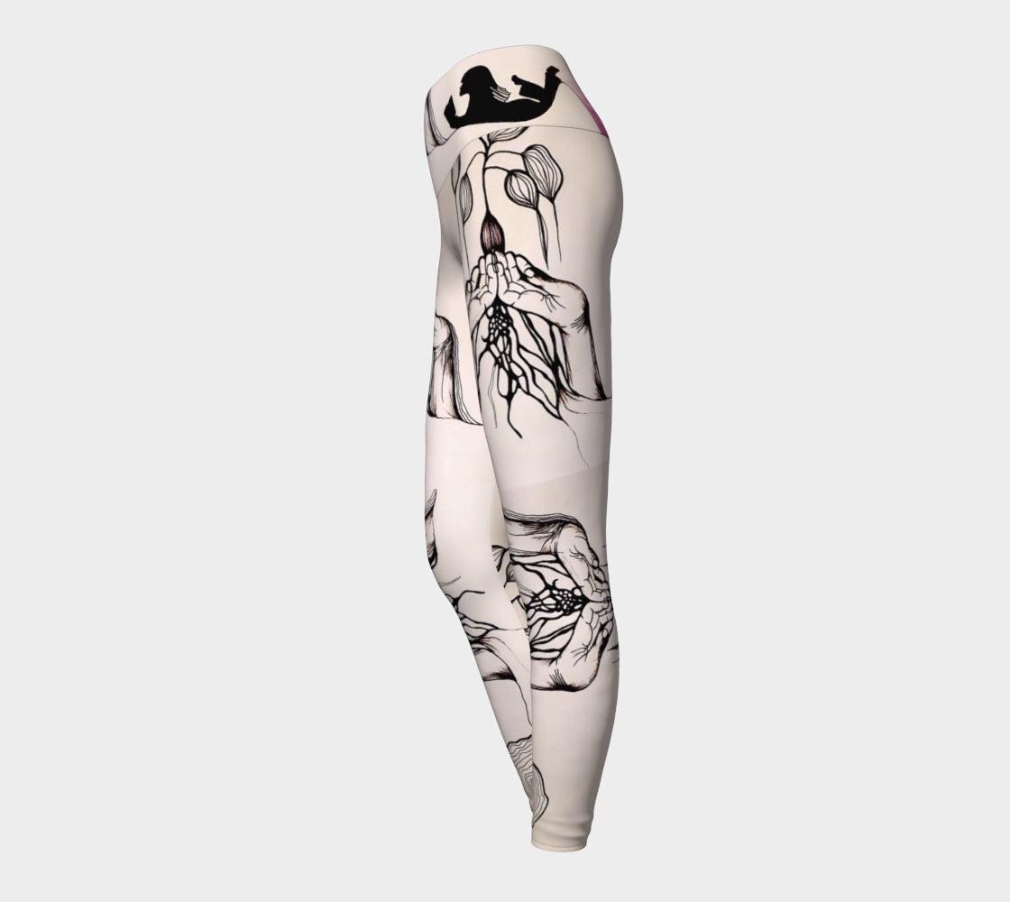 Black and white yoga leggings with designs of hands and plants and subtle hues of pink of them