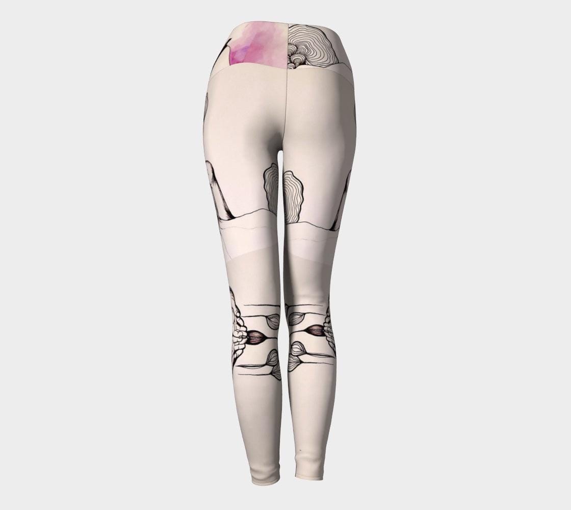 Black and white yoga leggings with designs of hands and plants and subtle hues of pink of them