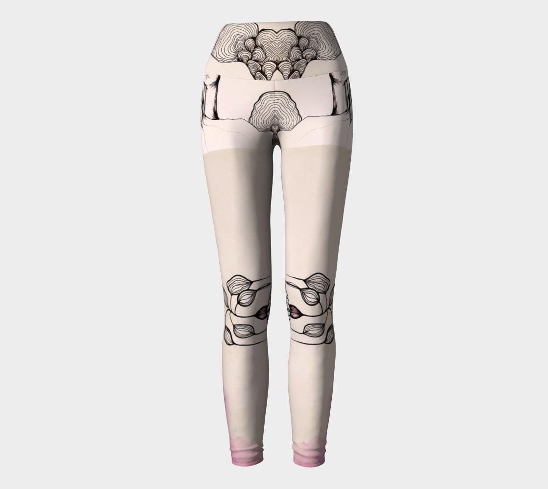 Black and white yoga leggings with designs of hands and plants and subtle hues of pink of them