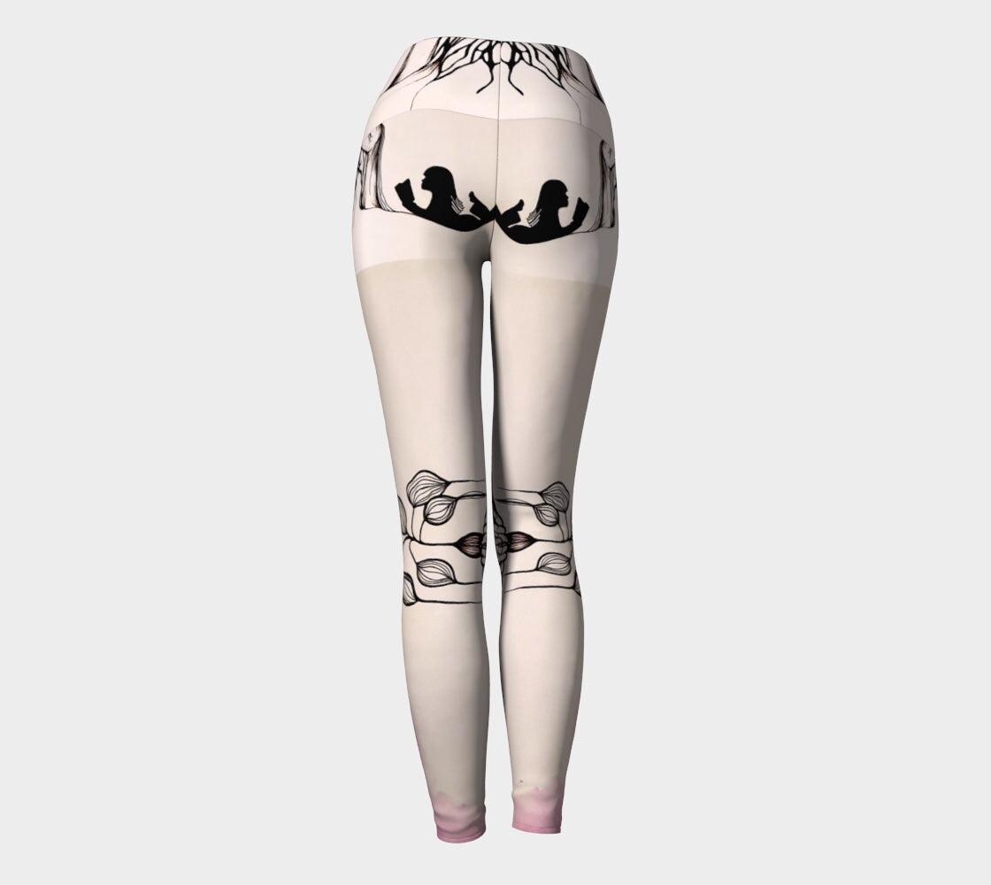 Black and white yoga leggings with designs of hands and plants and subtle hues of pink of them
