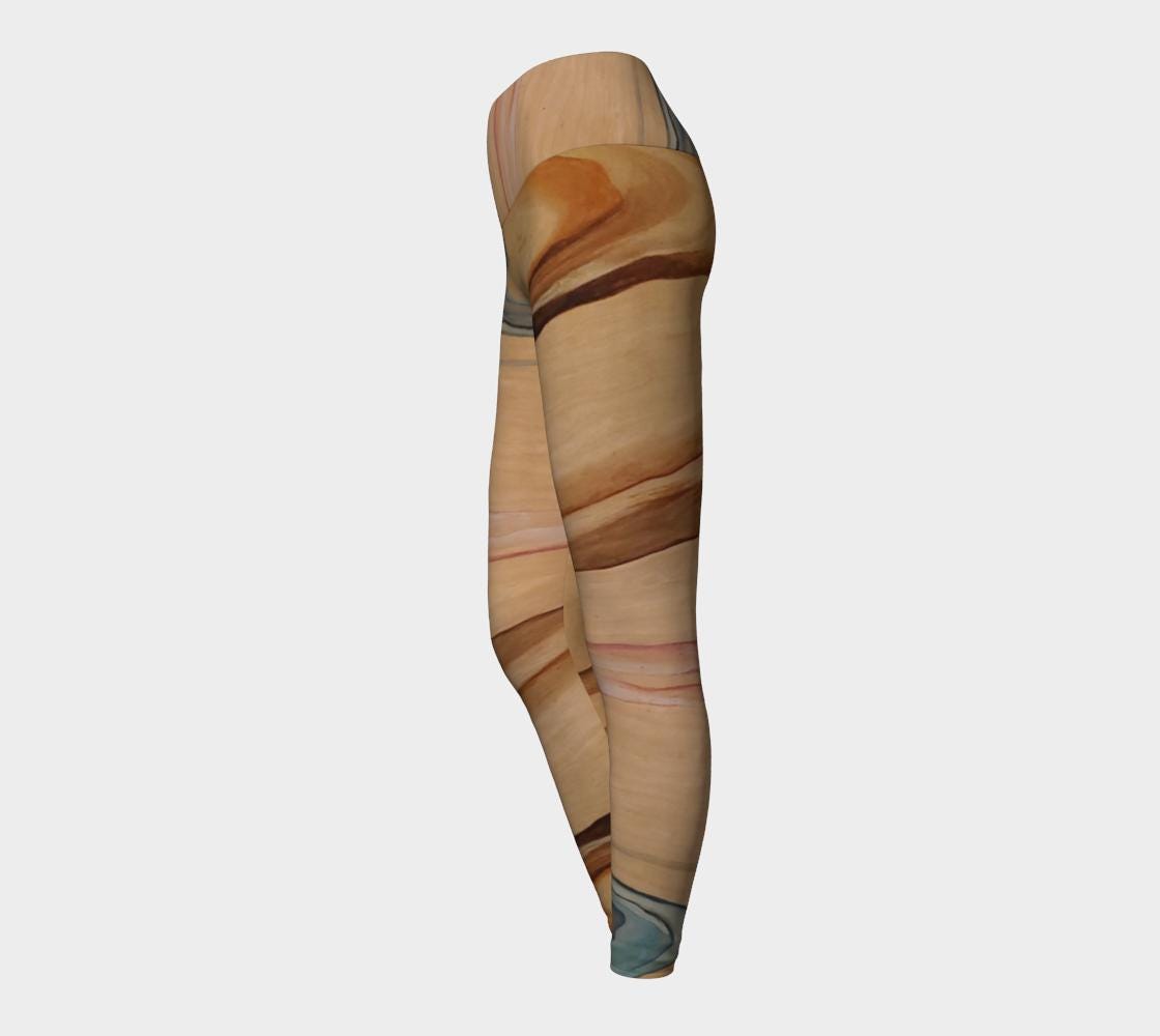 Yoga leggings in shades of brown and beige and blue and pink on reclaimed wood grain