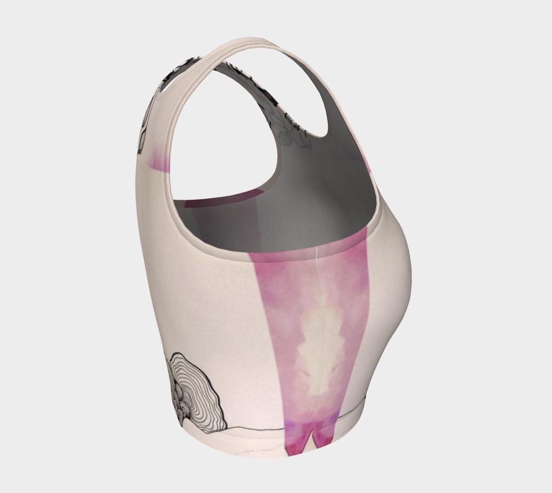 A beige yoga top with a floral and fungal design, featuring leaf patterns and what appears to be a stylized mushroom.
