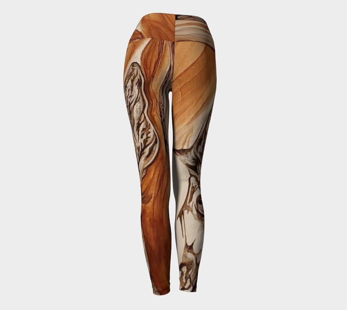 Yoga leggings in shades of rust and brown with the face of a doe drawn on them in black and white lines