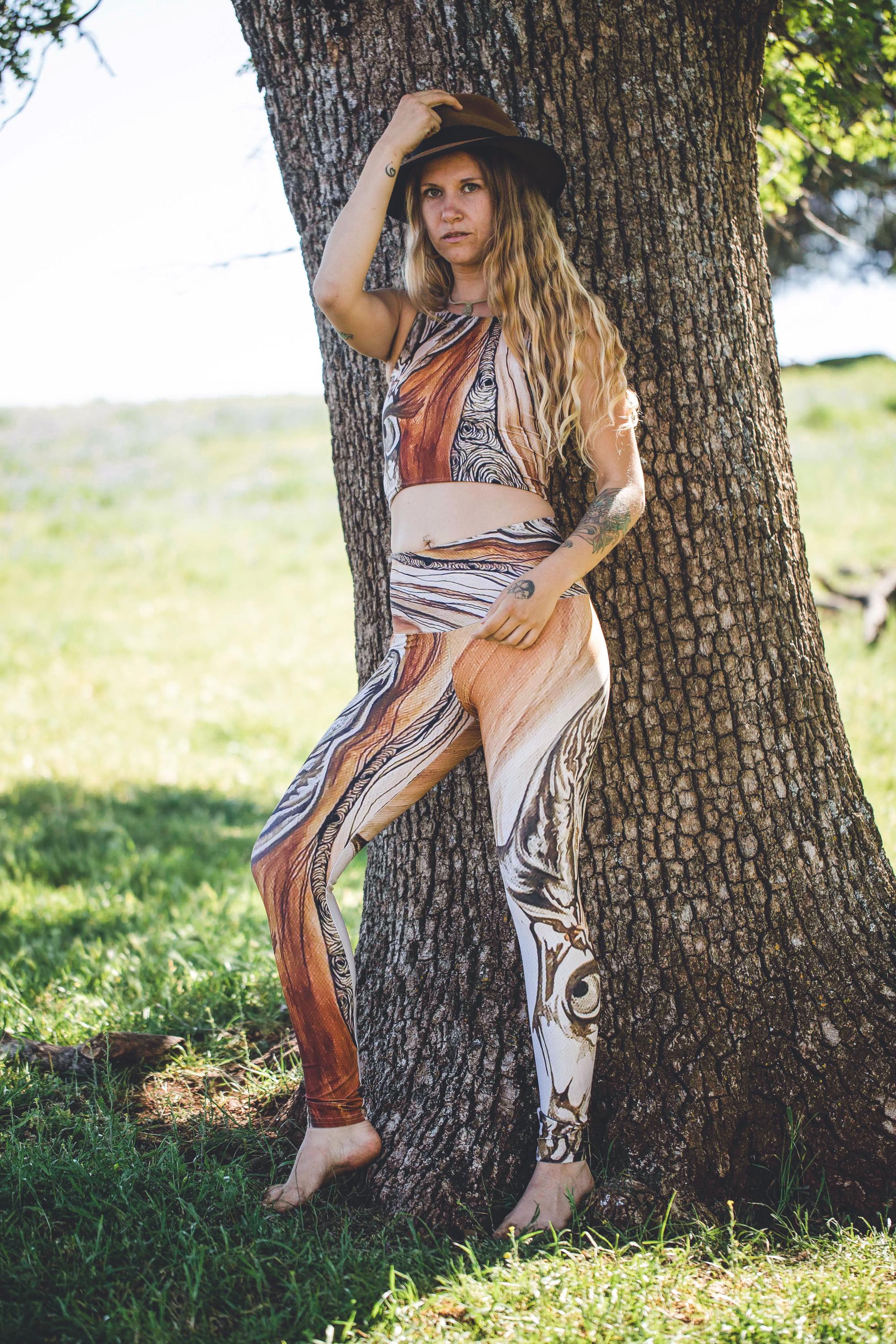 yoga set featuring a nature-inspired geometric pattern with earth tones in shades of rust and brown with the face of a doe drawn on them in black and white lines