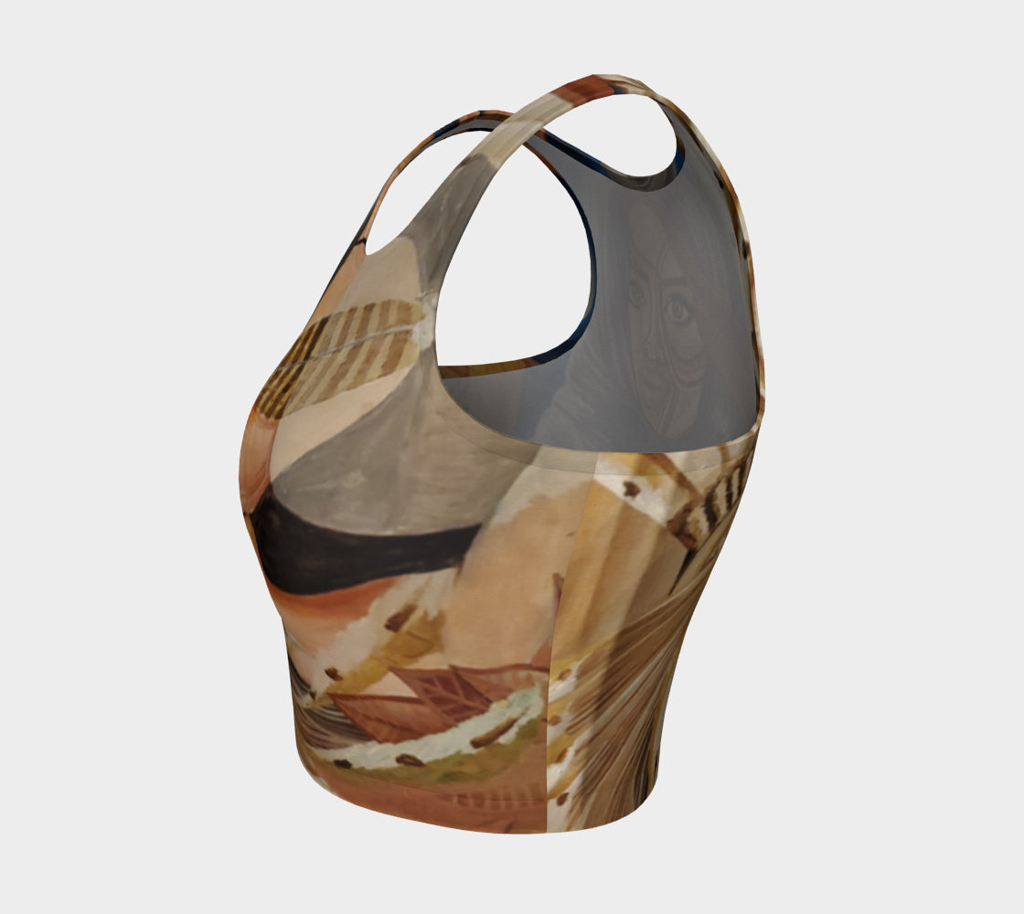 A multicolored, abstract design yoga top with a mix of geometric and organic patterns, featuring feathers and faces.