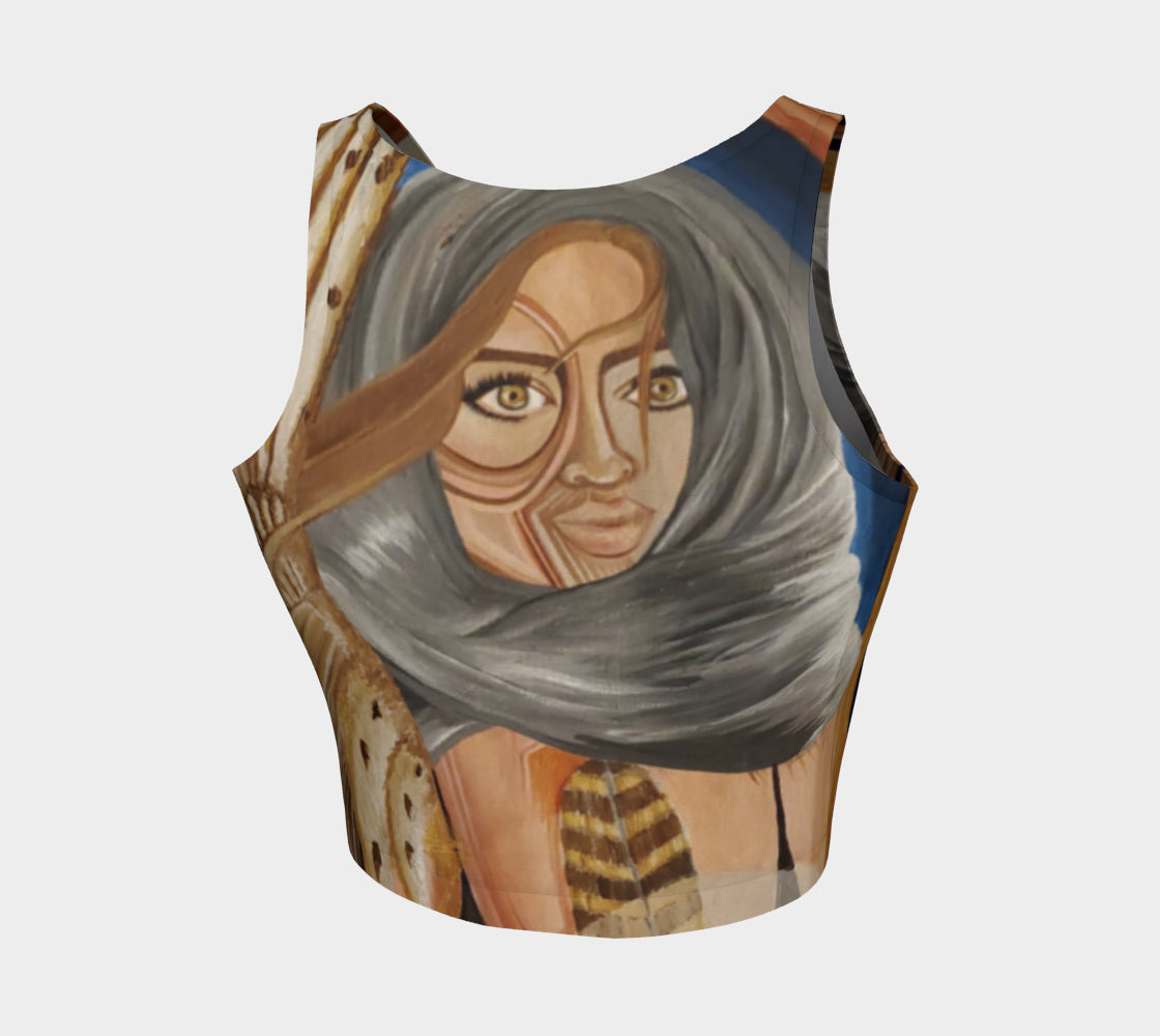 A multicolored, abstract design yoga top with a mix of geometric and organic patterns, featuring feathers and faces.