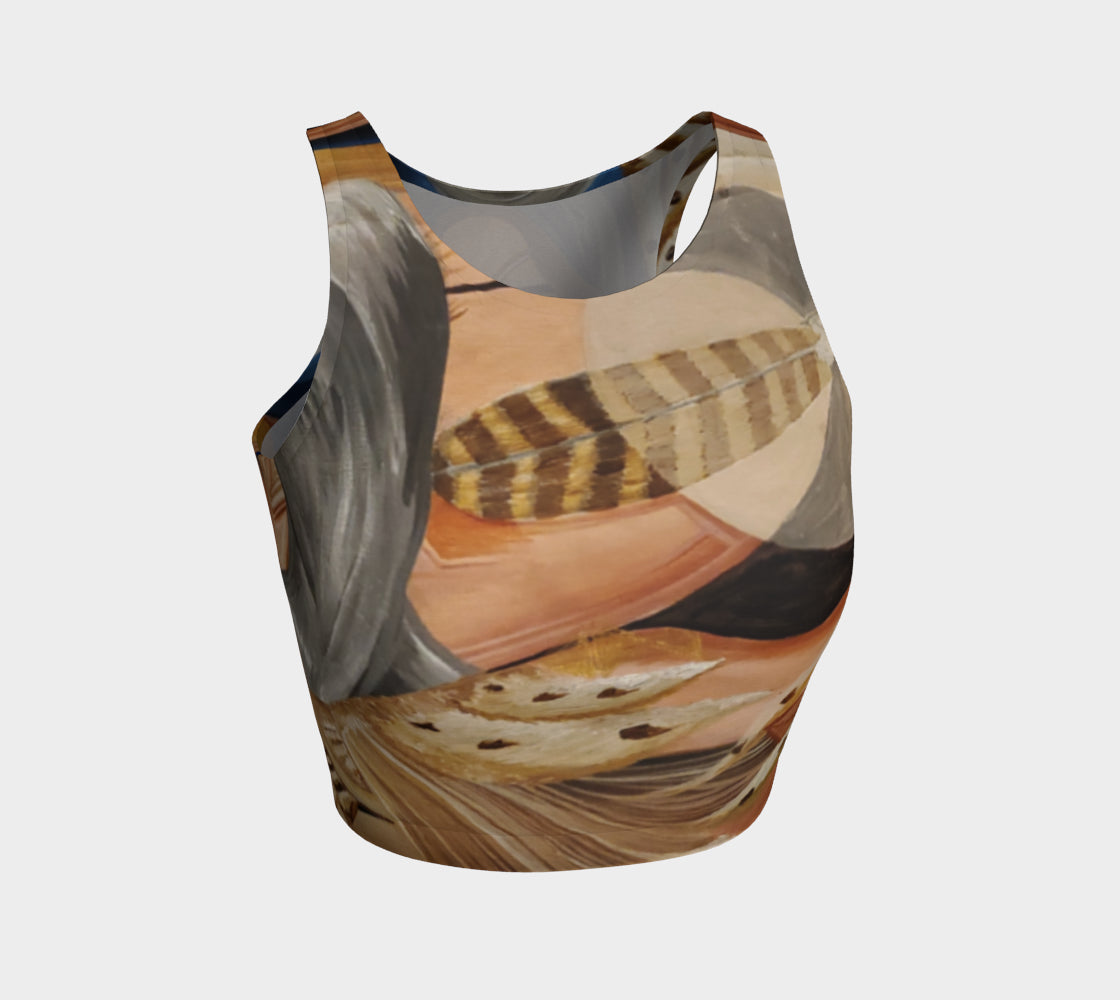 A multicolored, abstract design yoga top with a mix of geometric and organic patterns, featuring feathers and faces.