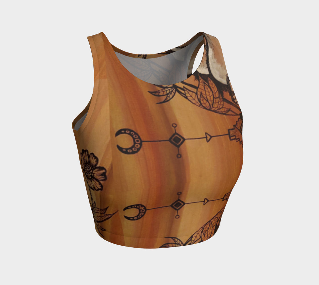 A cropped tank top with a floral leaf line and crescent moon designs on a golden brown background.