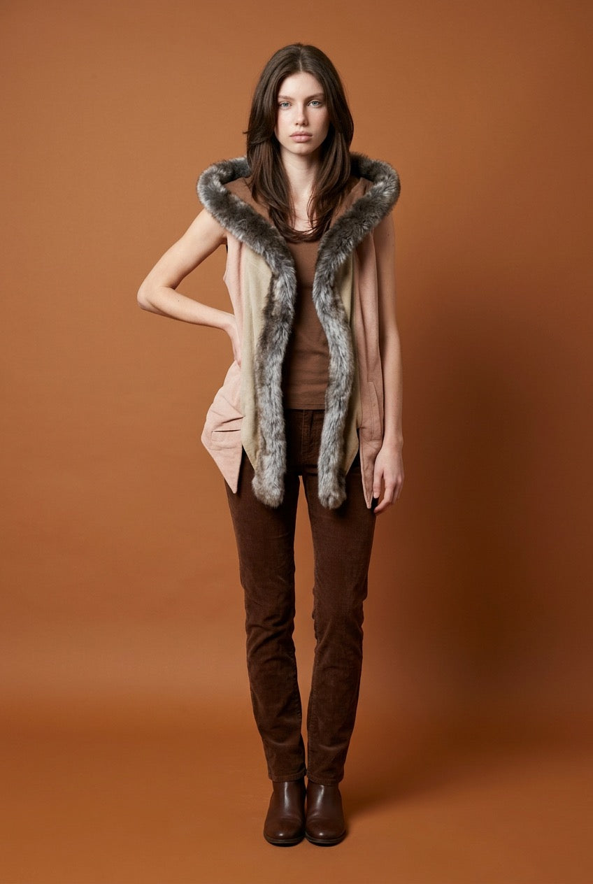 Woman wearing a faux fur-trimmed vest on an orange background